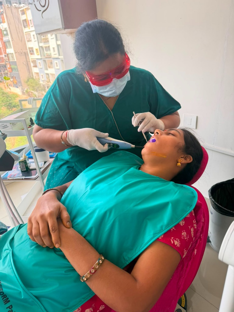 Dr. G. Mrudula performing laser dental treatment